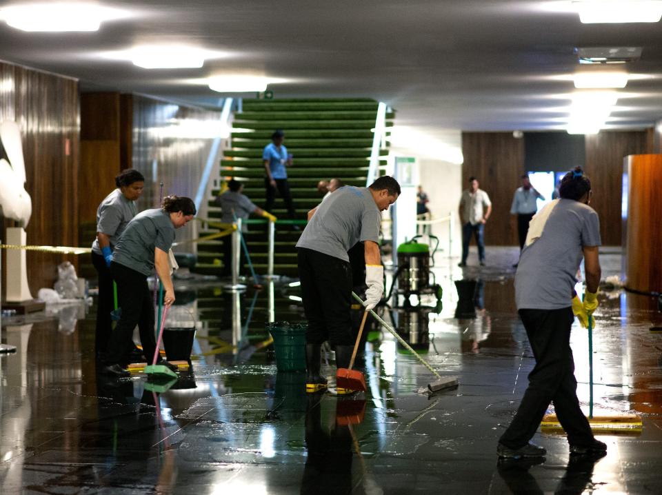 Employees clean the building at the Brazilian National Congress following a riot