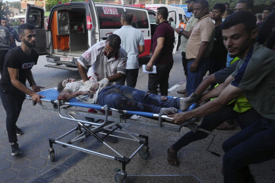 Palestinians wounded in the Israeli bombardment of the Gaza Strip are brought to a treatment room of al Aqsa Hospital in Deir al Balah on Tuesday, Oct. 31, 2023. (AP Photo/Adel Hana)