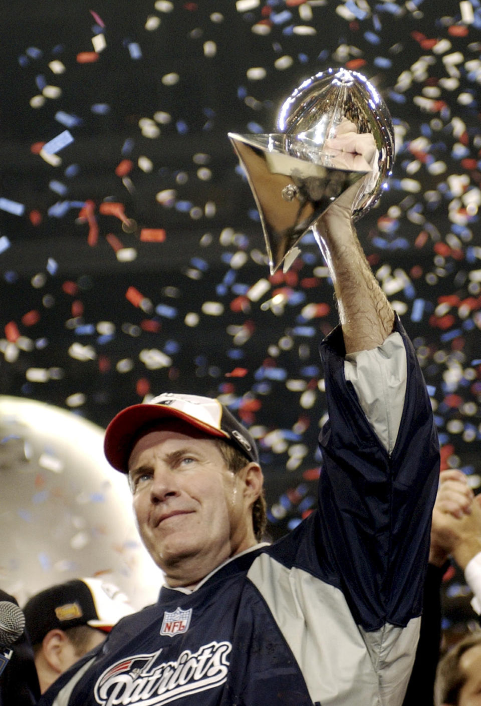 FILE - New England Patriots coach Bill Belichick holds the Vince Lombardi Trophy after the Patriots beat the Carolina Panthers 32-29 in Super Bowl XXXVIII in Houston, Texas, Feb. 1, 2004. Six-time NFL champion Bill Belichick has agreed to part ways as the coach of the New England Patriots on Thursday, Jan. 11, 2024, bringing an end to his 24-year tenure as the architect of the most decorated dynasty of the league’s Super Bowl era, a source told the Associated Press on the condition of anonymity because it has not yet been announced. (AP Photo/Dave Martin, File)