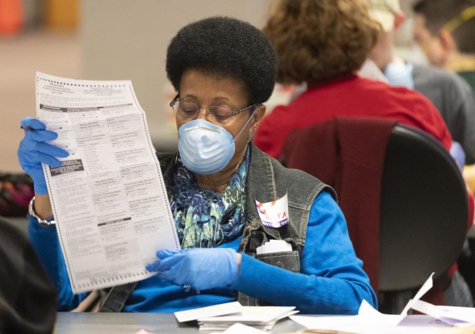 State election commission workers process absentee ballots in Wisconsin’s presidential primary election.