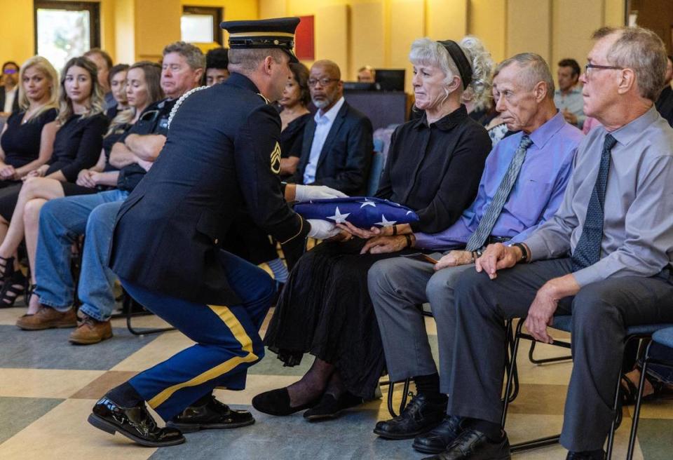 The Idaho Army National Guard Honor Guard presents a folded flag to Nick Maimer’s mother, Vivian Maimer Strnad, during his memorial service held at Boise Unitarian Universalist Fellowship on Sept. 20, 2023.
