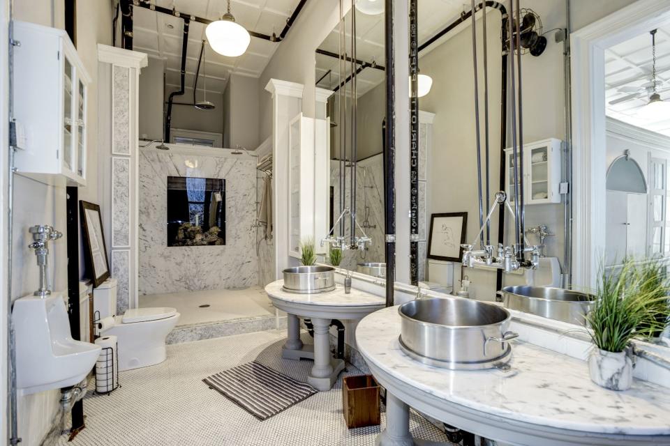 The master bathroom retains a distinct feature from its days as a school bathroom.