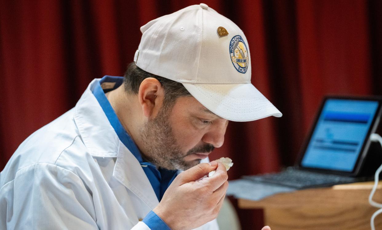 Arnoldo-Lopez-Hernandez, a judge from UW-Madison, smells an entry at the World Cheese Championships on Tuesday.