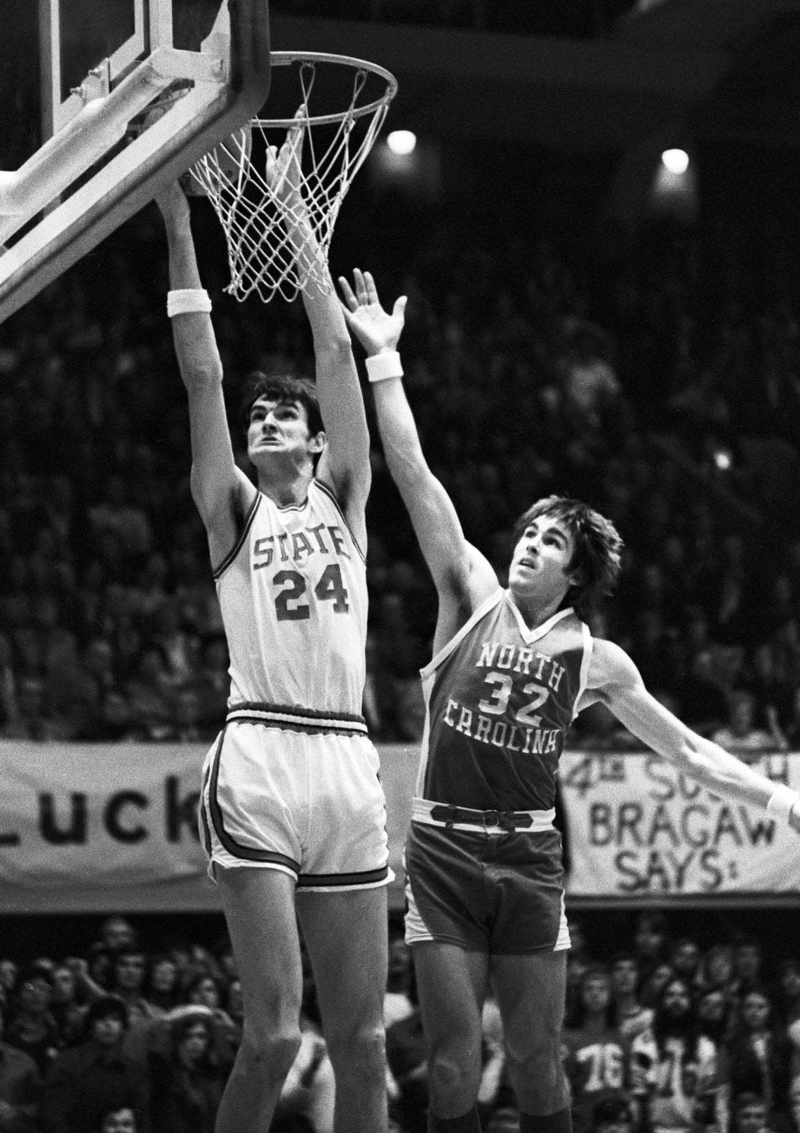 NC State center Tommy Burleson goes to the basket against UNC’s Darrell Elson in 1974 action in Reynolds Coliseum.