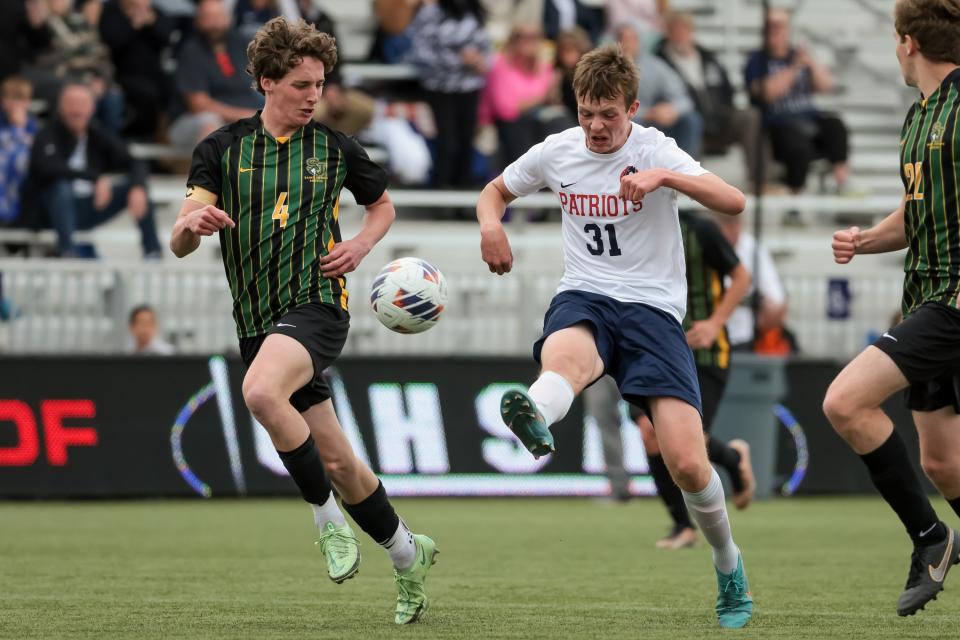 St. Joseph’s Keaton Gill and American Heritage’s Spencer Thompson move the ball in a 2A boys soccer state semifinal at Zions Bank Stadium in Herriman on Wednesday, May 10, 2023. | Spenser Heaps, Deseret News