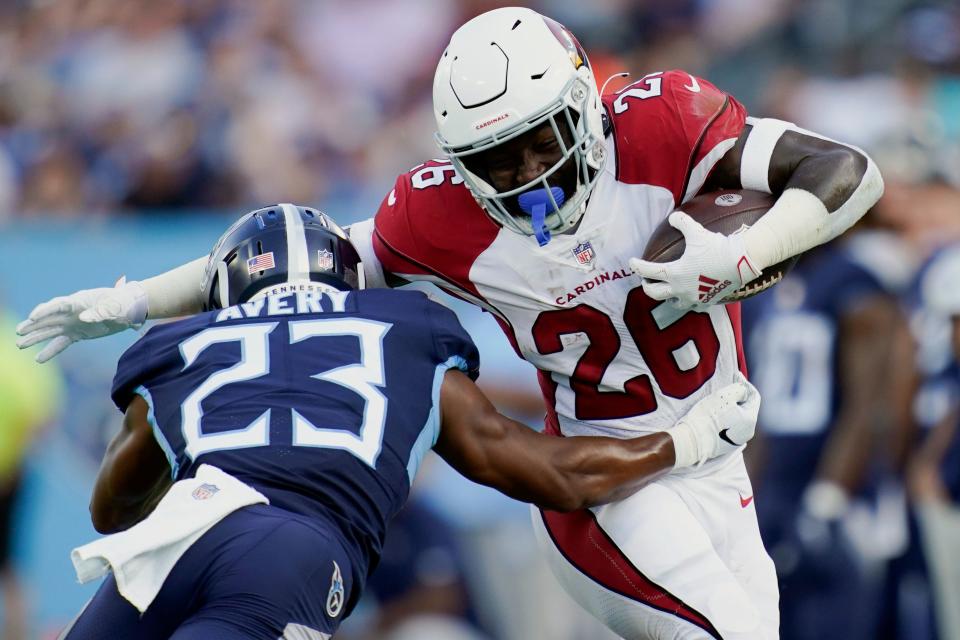 Aug 27, 2022; Nashville, Tennessee, USA; Arizona Cardinals running back Eno Benjamin (26) runs the ball against Tennessee Titans cornerback Tre Avery (23) during the first quarter of a preseason game at Nissan Stadium.