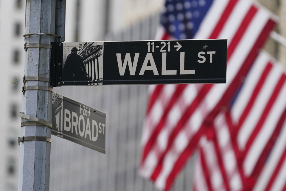 FILE - A street sign is seen in front of the New York Stock Exchange in New York, Tuesday, June 14, 2022. Wall Street headed lower early Tuesday, Dec. 5, 2023, after Moody's Investor Service downgraded China's sovereign debt rating as the country's real estate crisis seeps into its local government and private financing. (AP Photo/Seth Wenig, File)