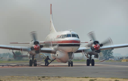 A ground crew fills a Conair airtanker with fire retardant at the Provincial Wildfire Coordination Centre at Kamloops Airport in Kamloops, British Columbia, Canada July 8, 2017. REUTERS/Dennis Owens