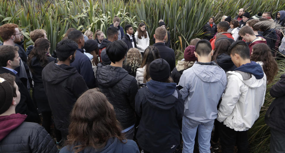 Students from the Marjory Stoneman Douglas High School in Parkland, Florida, gather after planting trees at Halswell Quarry Park Conservation Area on the outskirts of Christchurch, New Zealand, Tuesday, July 24, 2018. The 28 students who survived the Feb. 14, 2018, mass-shooting at the Florida school are visiting New Zealand to learn more about sustaining youth movements. After planting the native totara trees on Tuesday, they recounted memories of their former classmates and teachers in a ceremony that brought many to tears. (AP Photo/Mark Baker)