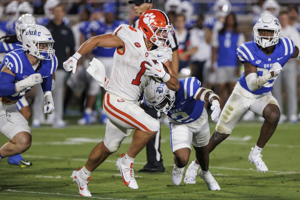 Clemson's Will Shipley (1) carries the ball as Duke's Jaylen Stinson (2) attempts a tackle during the first half of an NCAA college football game in Durham, N.C., Monday, Sept. 4, 2023. (AP Photo/Ben McKeown)