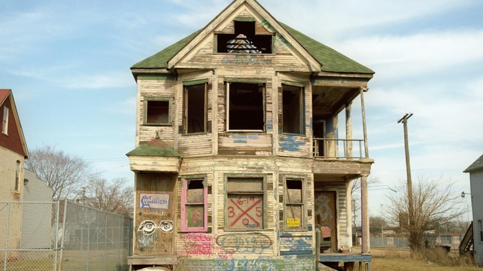 A run-down, abandoned house with graffiti on it, Detroit, Michigan, USA.