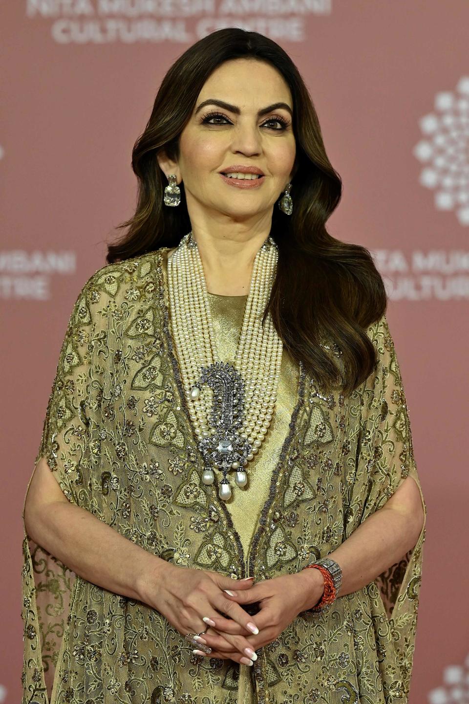 Nita Mukesh Ambani, founder and chairperson of Reliance Foundation, is a vision in gold, wearing a metallic-esque wrap.