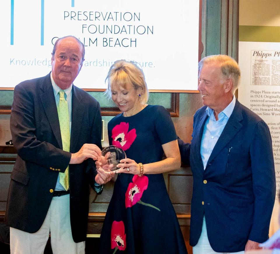 John Schuler Jr., left, presents the 2024 Elizabeth L. and John H. Schuler Award, which is named for his late parents, to homeowners Irina Liner and her husband, Marcel van Poecke, who built the award-winning house at 726 Hi Mount Road. The April 12 award presentation at the Preservation Foundation of Palm Beach also recognized the architectural firm Fairfax, Sammons & Partners.