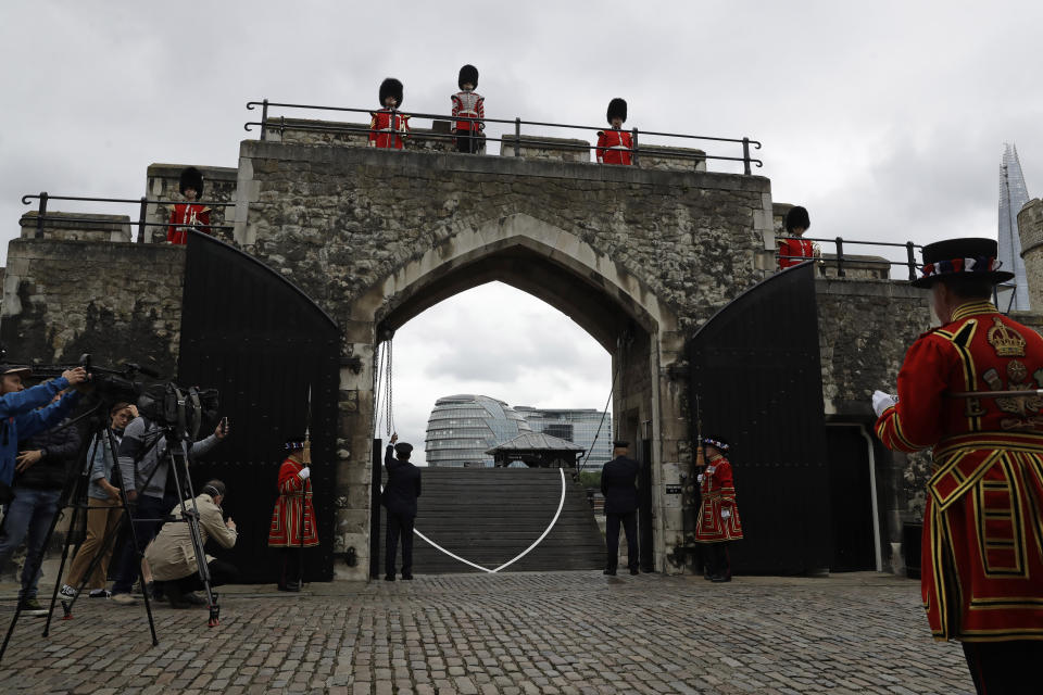 A drawbridge is lowered during a ceremony with Yeoman Warders and guardsmen to mark the reopening of the Tower of London for visitors, in London, as the British government continues to relax its coronavirus restrictions, Friday, July 10, 2020. (AP Photo/Matt Dunham)