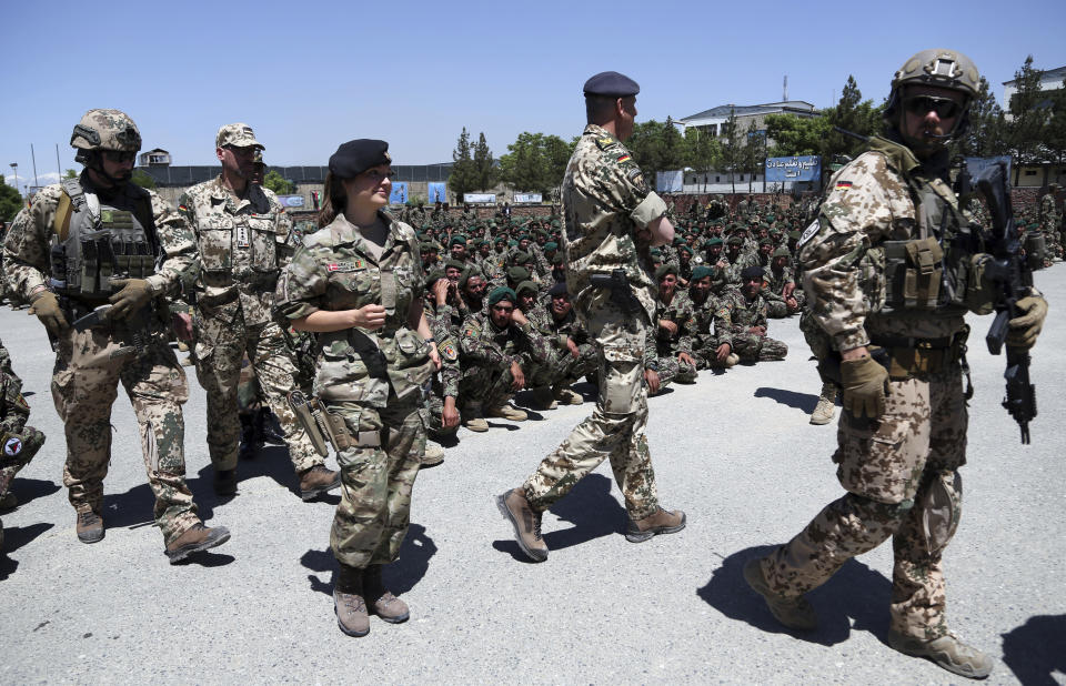 NATO forces attend during the graduation ceremony of Afghan National Army soldiers from a 3-month training program at the Afghan Military Academy in Kabul, Afghanistan, Monday, May 27, 2019. (AP Photo/Rahmat Gul)