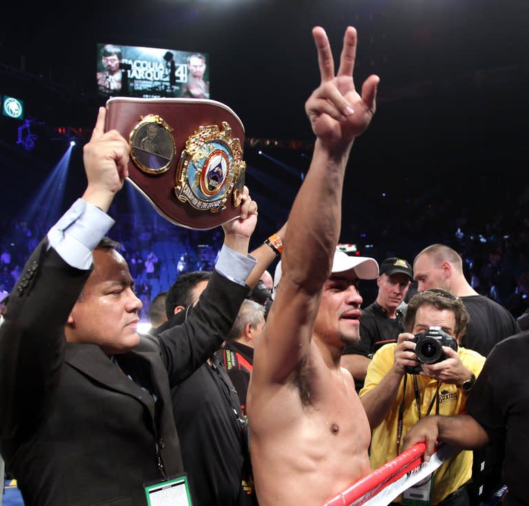 Juan Manuel Marquez waves to the crowd after knocking out Manny Pacquiao. Marquez knocked Pacquiao down in the third round then ended the fight with a savage overhand right that hit Pacquiao flush, sending him down hard. Marquez had held his own in their first three fights but had never even knocked down Pacquiao until Saturday night