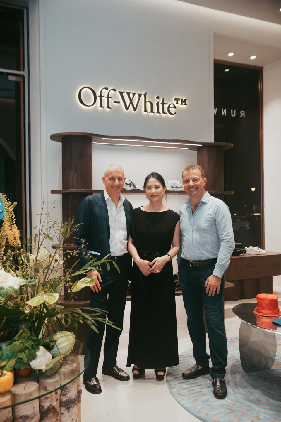 Anh Tran, founder of Runway Vietnam, middle, with guests at the opening of Runway Vietnam store at Diamond Plaza