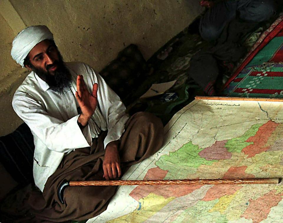 FILE - In this April 1998 file photograph, al-Qaida leader Osama bin Laden is shown in Afghanistan. Years after the death of his father at the hands of a U.S. Navy SEAL raid in Pakistan, Hamza bin Laden himself clearly in the crosshairs of world powers. The U.S. has put up to a $1 million bounty for him. The U.N. Security Council has named him to a global sanctions list, sparking a new Interpol notice for his arrest. His home country of Saudi Arabia has revoked his citizenship. (AP Photo, File)