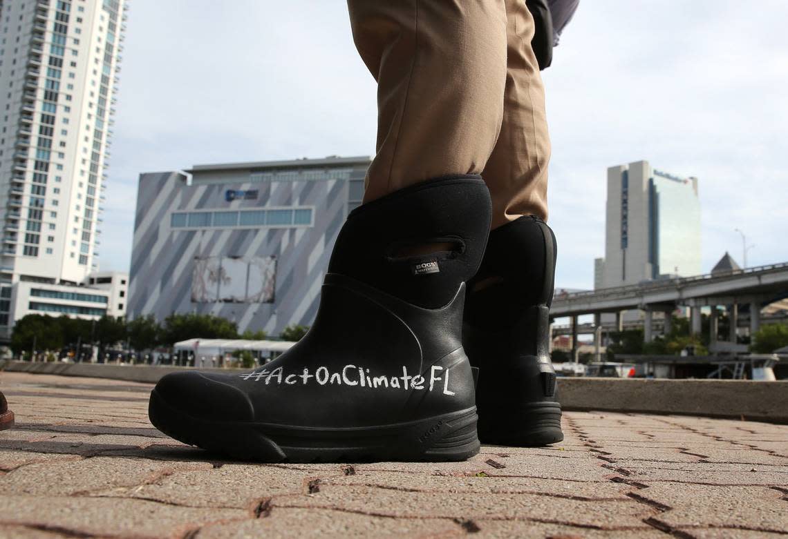 José Javier Rodríguez, then a state senator from Miami, wears a message about climate change on his rain boots as he inspects Jose Marti Park in Little Havana for signs of flooding during the morning King Tide on Oct. 9, 2018. FPL’s political consulting firm, Matrix, was involved in a ‘ghost candidate’ scheme that defeated him in the 2020 election. FPL CEO Eric Silagy had asked Matrix to make Rodríguez’s life “a living hell.”