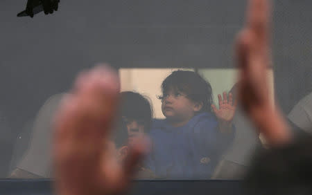 Children look out of a bus window as they wait with their families to cross into Egypt through the Rafah border crossing after it was opened by Egyptian authorities for humanitarian cases, in the southern Gaza Strip February 8, 2018. REUTERS/Ibraheem Abu Mustafa