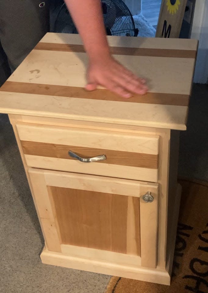 Ryan Prendergast runs his hand over glass-smooth finish of a nightstand he built in the fine woodworking shop at Bucks County Technical High School. "Having my own shop is really my dream,” he said.