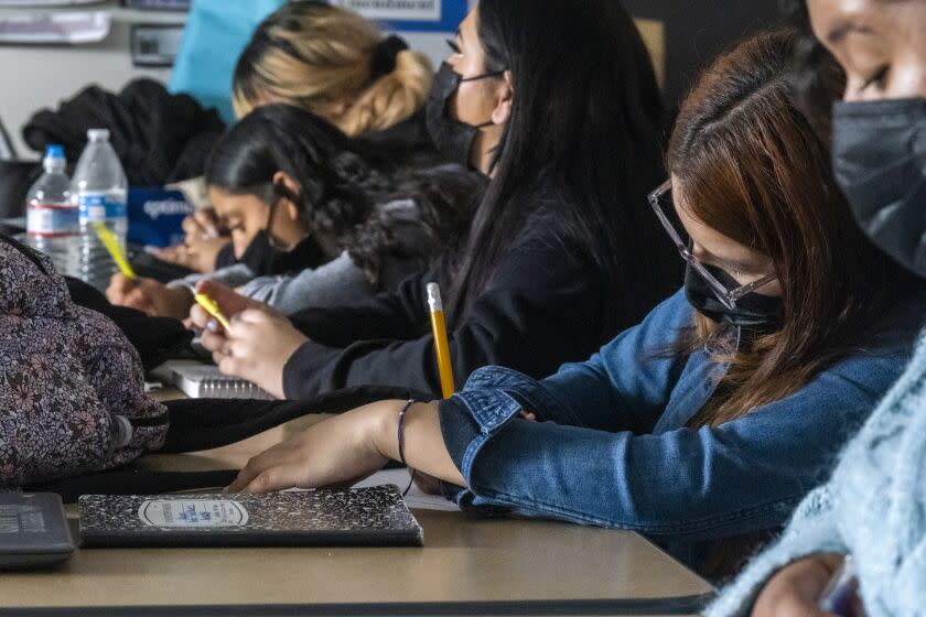 LOS ANGELES, CA - MARCH 02: Atiana Pineda-Rodriguez, 16, (wearing glasses) takes note during a history class at Sotomayor Arts and Sciences Magnet on Wednesday, March 2, 2022 in Los Angeles, CA. The class today is focused on Ukraine and Russia. (Francine Orr / Los Angeles Times)