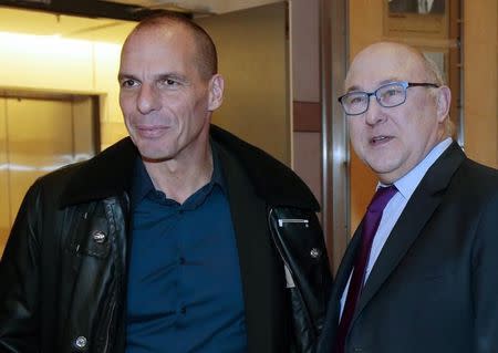 French Finance Minister Michel Sapin (R) and Greek Finance Minister Yanis Varoufakis pose before a meeting at the Bercy Finance Ministry in Paris February 1, 2015. REUTERS/Jacques Demarthon/Pool