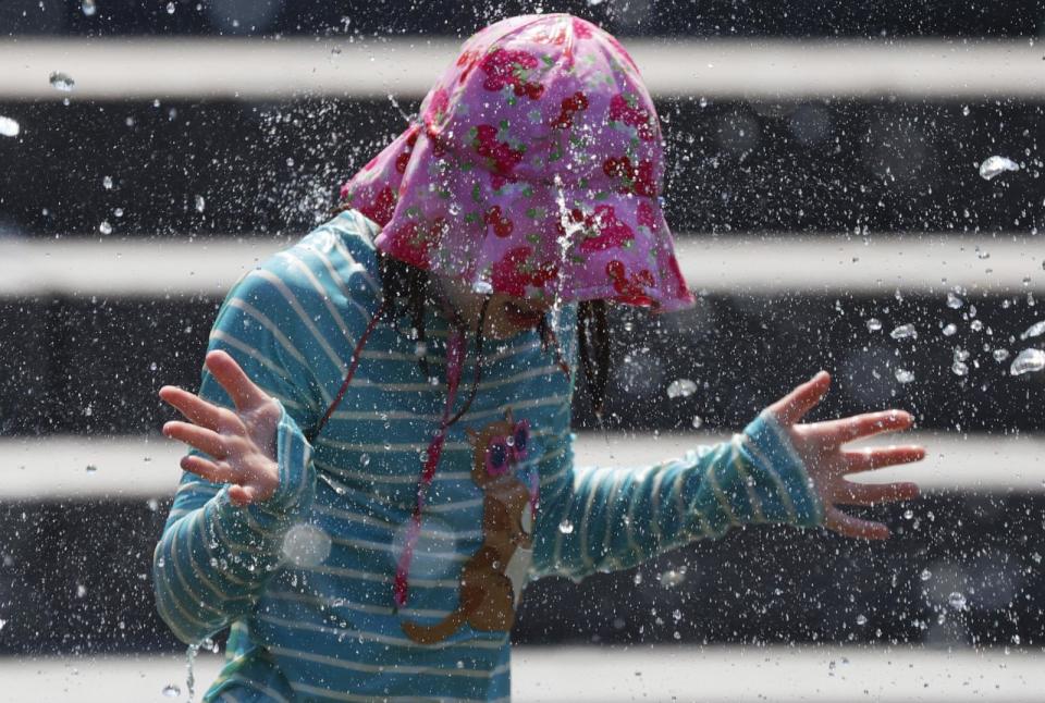 PHOTO: A child cools off in the fountain at Washington Square Park in New York City on June 19, 2024. (John Angelillo/UPI via Shutterstock)