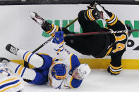 Boston Bruins right wing Chris Wagner (14) is upended by Buffalo Sabres defenseman Jacob Bryson (78) during the first period of an NHL hockey game Tuesday, April 13, 2021, in Boston. (AP Photo/Charles Krupa)