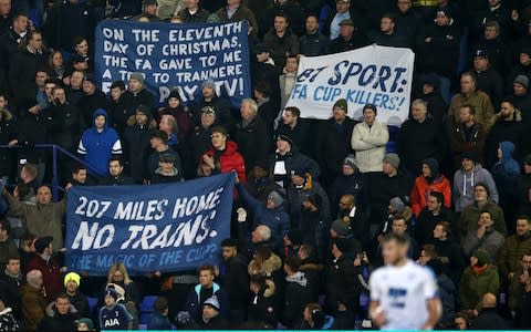 Spurs fans protest at their Friday-night kick-off away to Tranmere Rovers - Credit: GETTY IMAGES