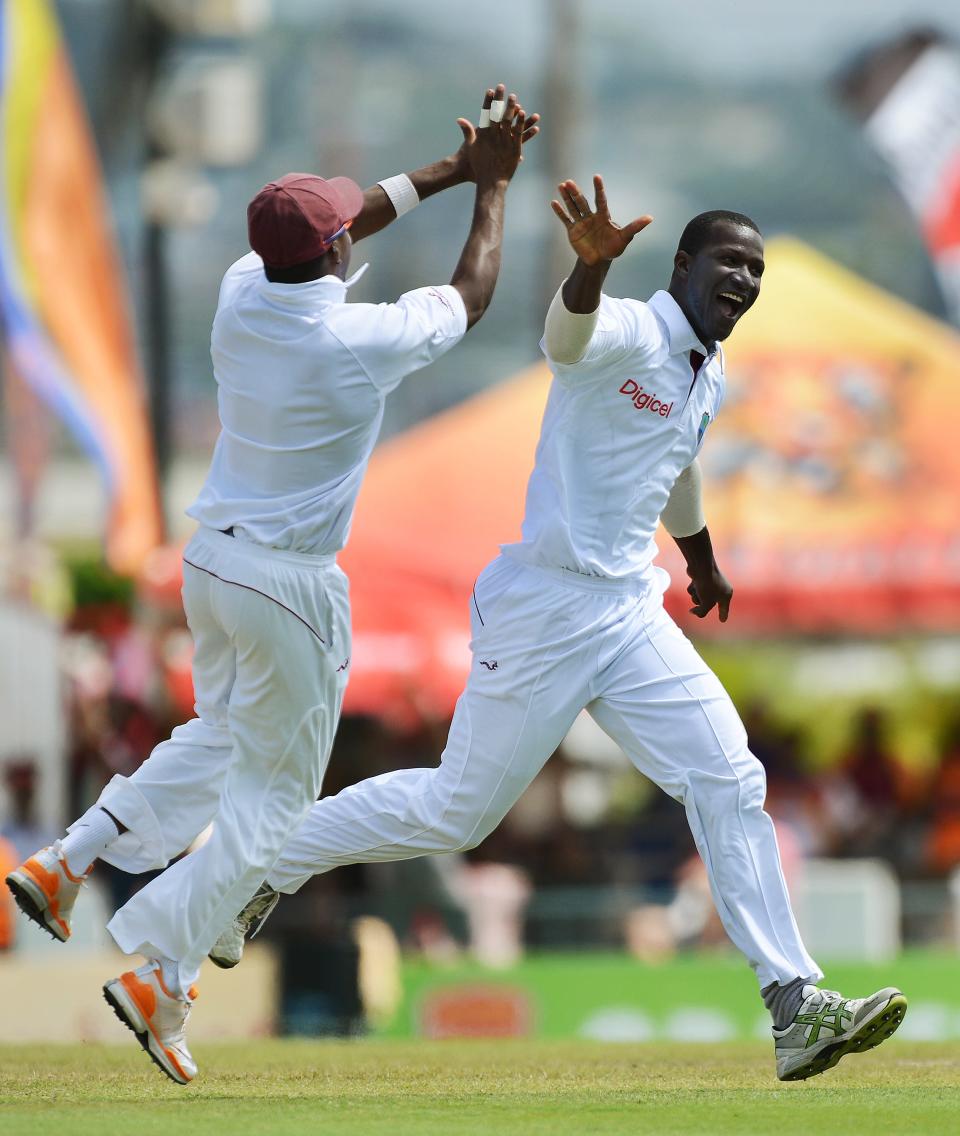 West Indies cricket team captain Darren Sammy (R) celebrates dismissing Australian batsman Ed Cowan during the third day of the first-of-three Test matches between Australia and West Indies at the Kensington Oval stadium in Bridgetown on April 9, 2012. West Indies scored of 449/9 at the end of their first innings. AFP PHOTO/Jewel Samad (Photo credit should read JEWEL SAMAD/AFP/Getty Images)