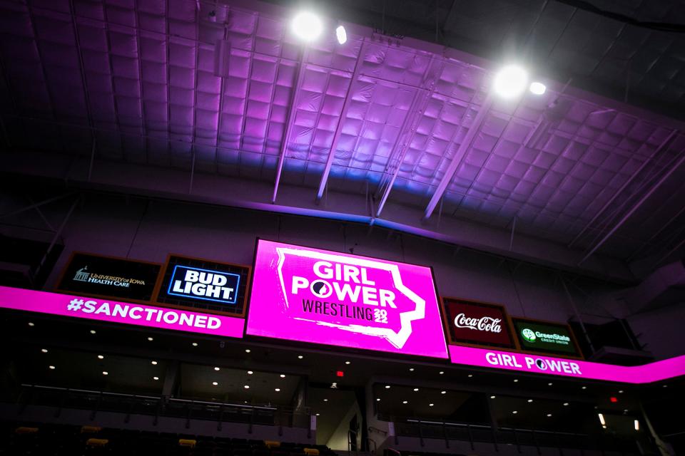 A graphic from the Iowa Girls High School Athletic Union reading "Girl Power Wrestling 2022" is seen after the finals of the Iowa Wrestling Coaches and Officials Association girls state wrestling tournament Jan. 22, 2022, at Xtream Arena in Coralville.