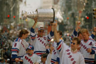 FILE - New York Rangers captain Mark Messier, joined by other members of the team, holds the Stanley Cup during the team's victory parade in New York City, June 17, 1994. No matter which team wins the Stanley Cup this year it will be a first this century. (AP Photo/Marty Lederhandler, File)
