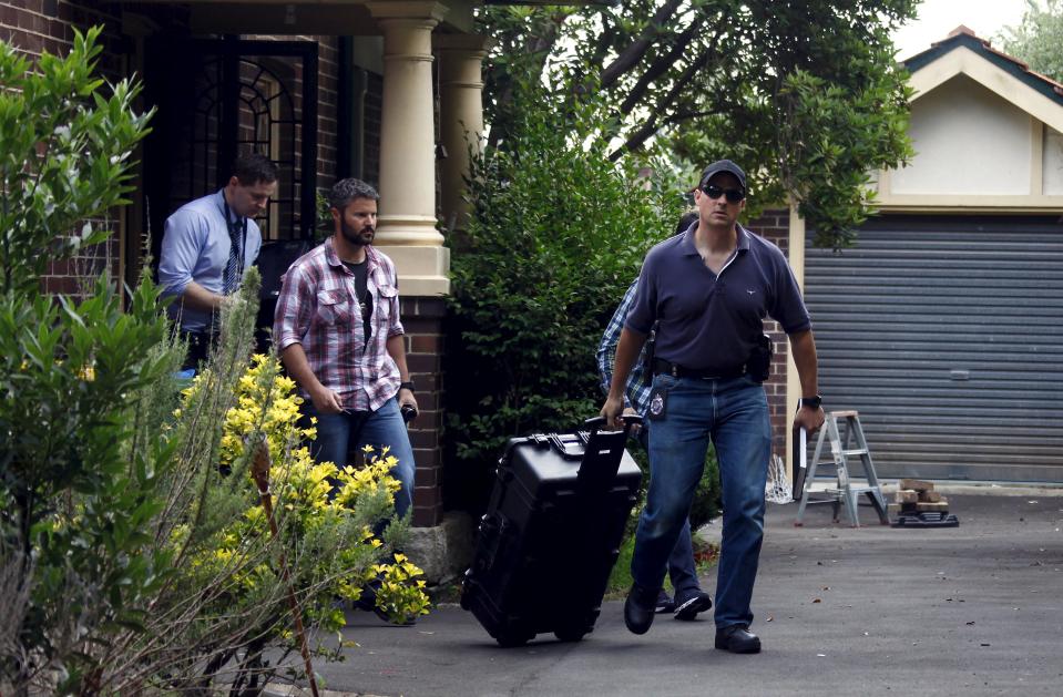 Australian Federal Police officers walk down the driveway after searching the home of probable creator of cryptocurrency bitcoin Craig Steven Wright in Sydney's north shore December 9, 2015. Australian Federal Police raided the Sydney home on Wednesday of the man named by Wired magazine as the probable creator of cryptocurrency bitcoin, a Reuters witness said. The property is registered under the Australian electoral role to Wright, whom Wired outed as the likely real identity of Satoshi Nakamoto, the pseudonymous figure that first released bitcoin's code in 2009. To match Exclusive AUSTRALIA-BITCOIN/ REUTERS/David Gray