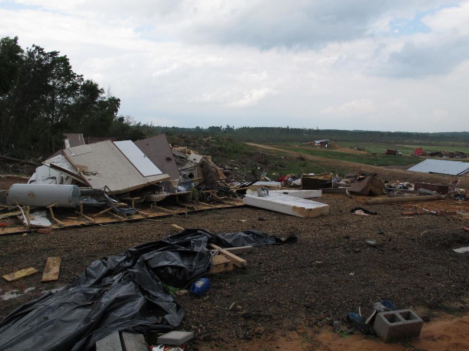 The remnants of a mobile home destroyed by Monday's tornado lay stacked and scattered on Tuesday, April 29, 2014 near Louisville, Miss. (AP Photo/Adrian Sainz)