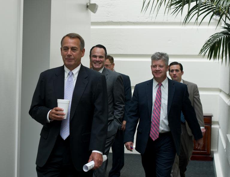 US House Speaker John Boehner (L) arrives at a meeting of Republican members of the House of Representatives on September 28, 2013 in Washington