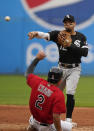 Chicago White Sox's Cesar Hernandez (12) gets Cleveland Indians' Yu Chang (2) at second base in the fourth inning in the first baseball game of a doubleheader, Thursday, Sept. 23, 2021, in Cleveland. Harold Ramirez was out at first base for the double play. (AP Photo/Tony Dejak)