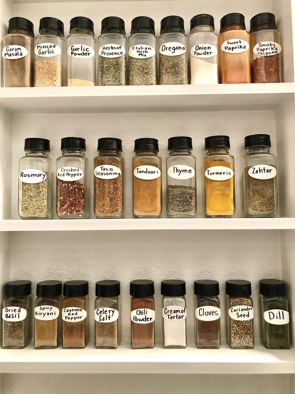 Large spice cabinet full of different kinds of herbs