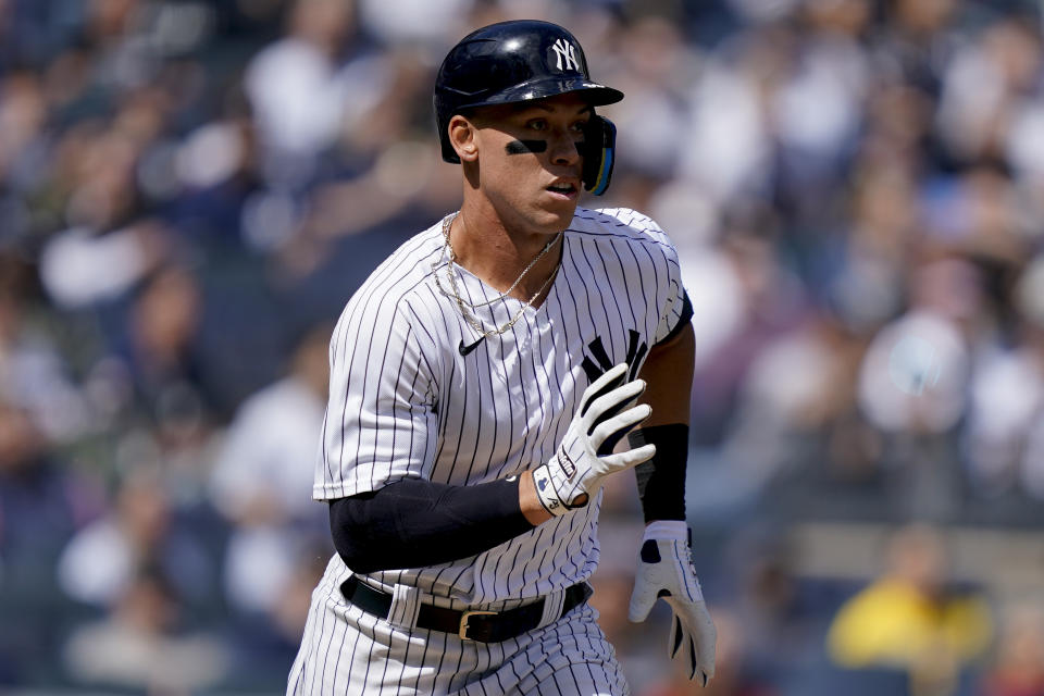 New York Yankees' Aaron Judge runs to first after hitting a single off Boston Red Sox starting pitcher Nathan Eovaldi in the first inning of an opening day baseball game, Friday, April 8, 2022, in New York. (AP Photo/John Minchillo)