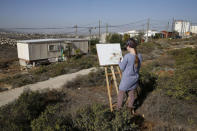 Hanna Horowitz, an Israeli resident of the Jewish settler outpost of Amona in the West Bank, draws a picture of the landscape in front of a caravan December 5, 2016. REUTERS/Baz Ratner