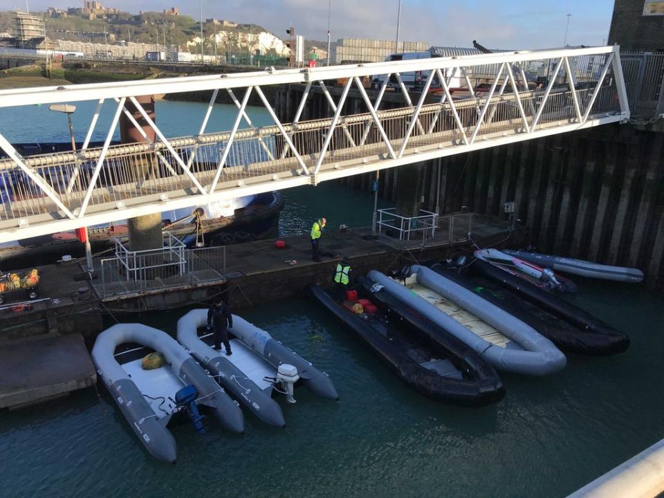 Border officials inspect a number of confiscated dinghies, with the two on the left believed to have been used in the Channel crossing on Thursday morning. (The Independent)