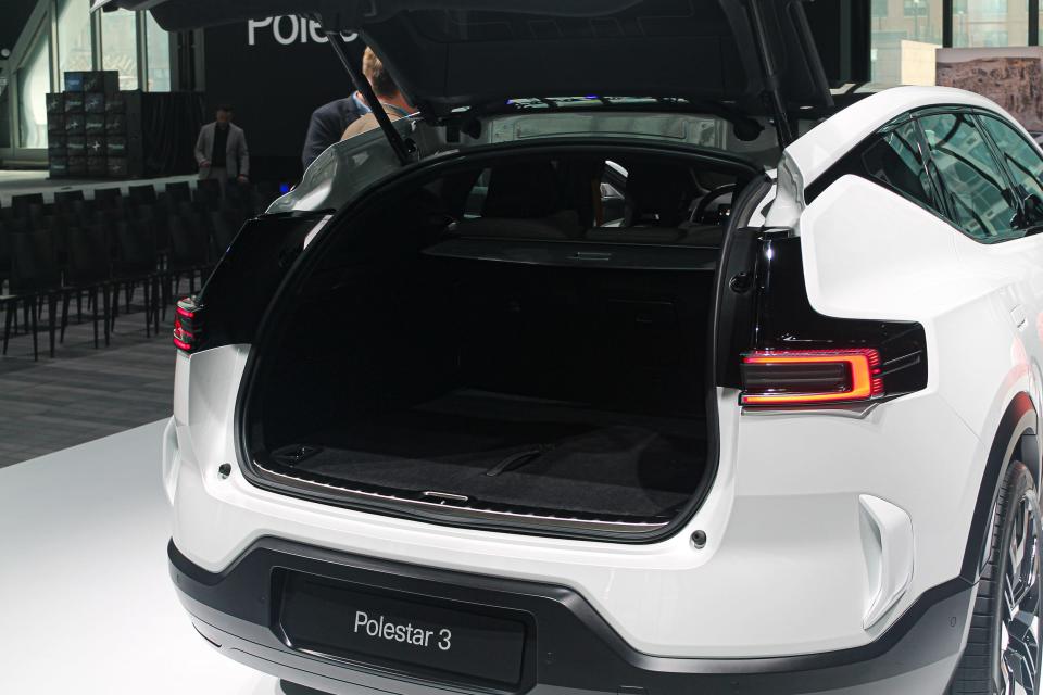 The Polestar 3 electric SUV, viewed from behind, with its cargo hatch open, exposing its cargo area.