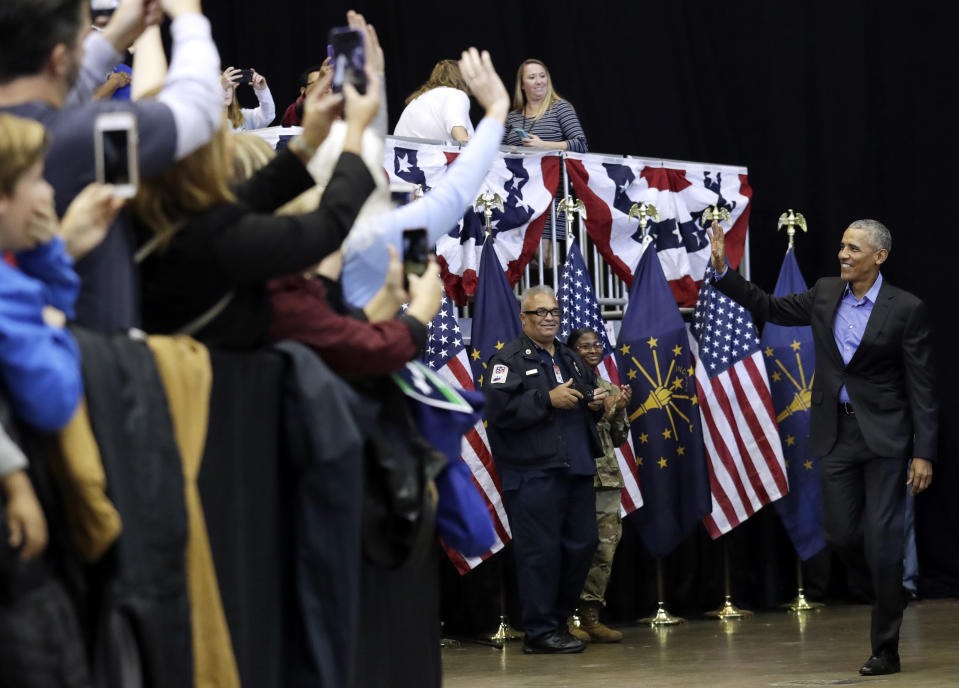 Former President Barack Obama, right, waves to supporters, Sunday, Nov. 4, 2018, in Gary, Ind. Obama rallied Democrats on behalf of Sen. Joe Donnelly, D-Ind., who faces a stiff challenge from Republican businessman Mike Braun. (AP Photo/Nam Y. Huh)