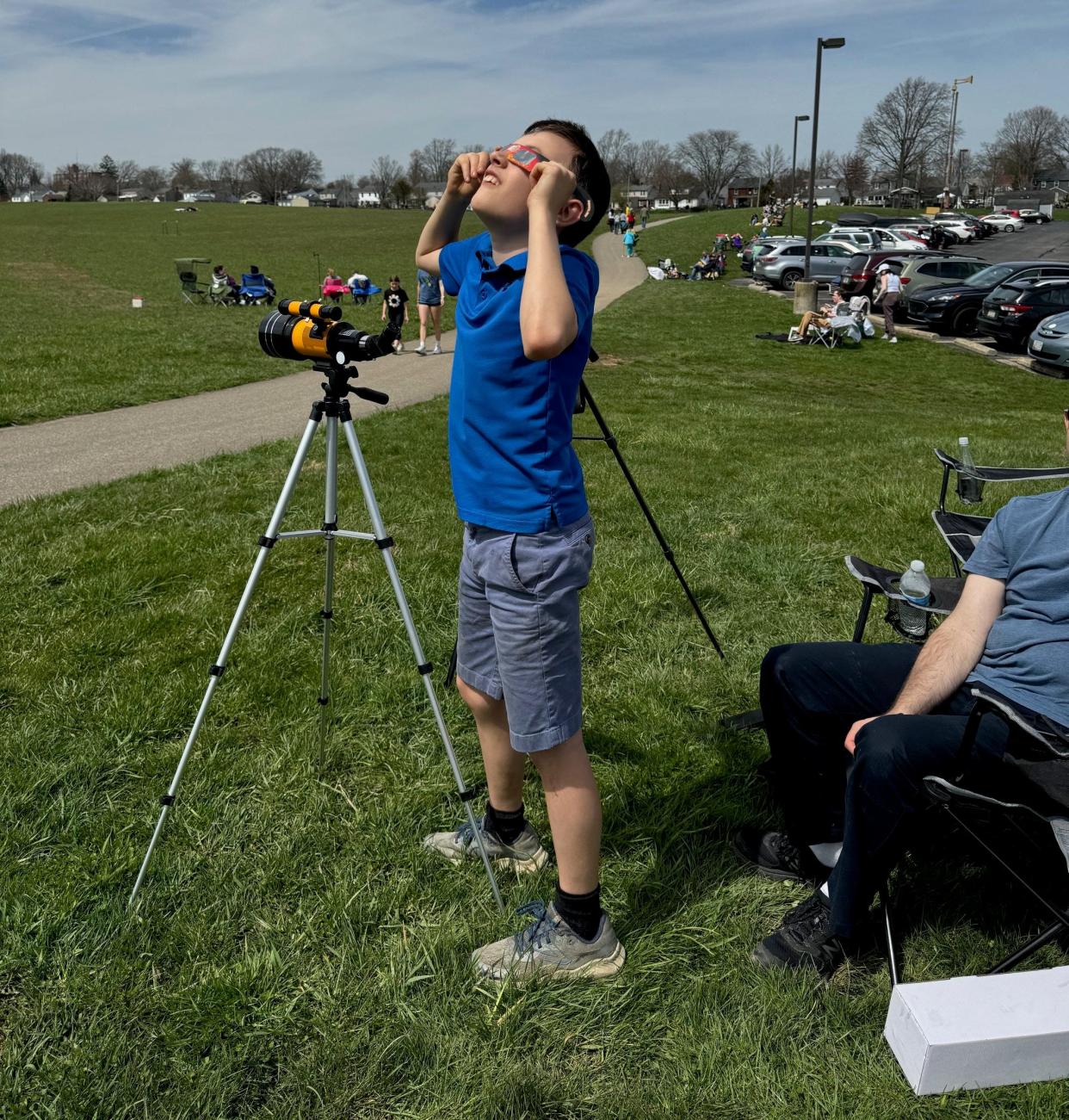 Thomas O'Callaghan, 11, from Gaithersburg, Md. spent the day of the solar eclipse with his family at Freer Field in Ashland and was eager to try out his eclipse glasses when the partial eclipse began about 3 p.m. on Monday.