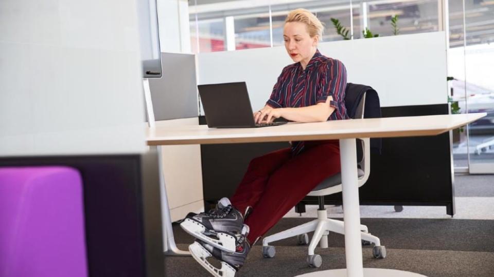 Woman in skates works on laptop