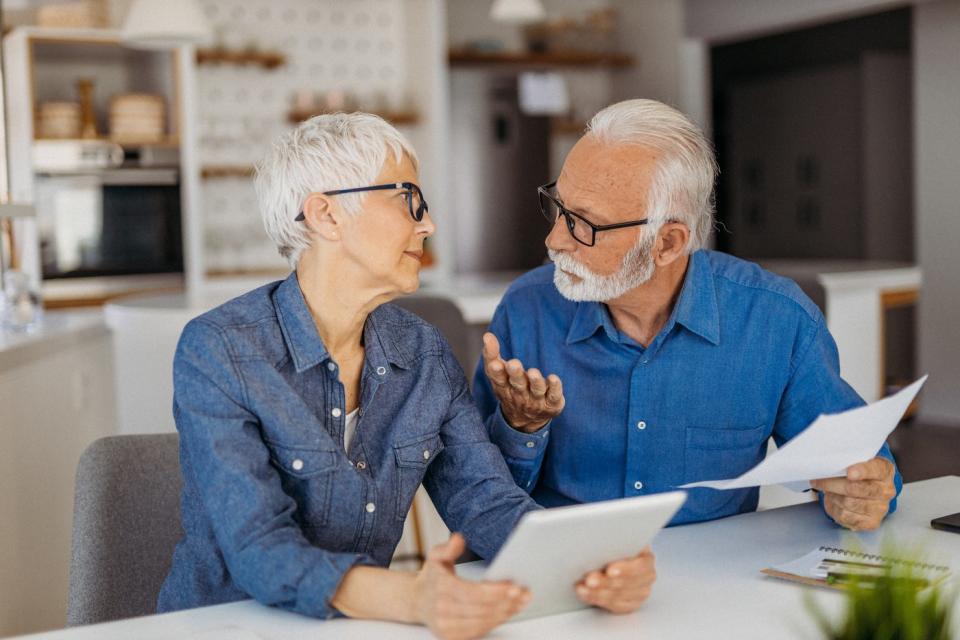 A couple engaged in discussion while sitting at a table.