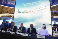 Etihad CEO Tony Douglas, left, Boeing Commercial Airplanes president and CEO Stanley A. Deal, second left, Boeing Global Services President and CEO Ted Colbert, third left and Etihad COO Mohammad al-Bulooki, right, attend a news conference at the Dubai Airshow in Dubai, United Arab Emirates, Monday, Nov. 18, 2019. Abu Dhabi's flagship carrier Etihad said Monday it had partnered with Boeing Co. to launch what they say will be one of the world's most fuel-efficient long haul airplanes as the company seeks to save costs on fuel and position itself as a more environmentally-conscious choice for travelers. (AP Photo/Jon Gambrell)