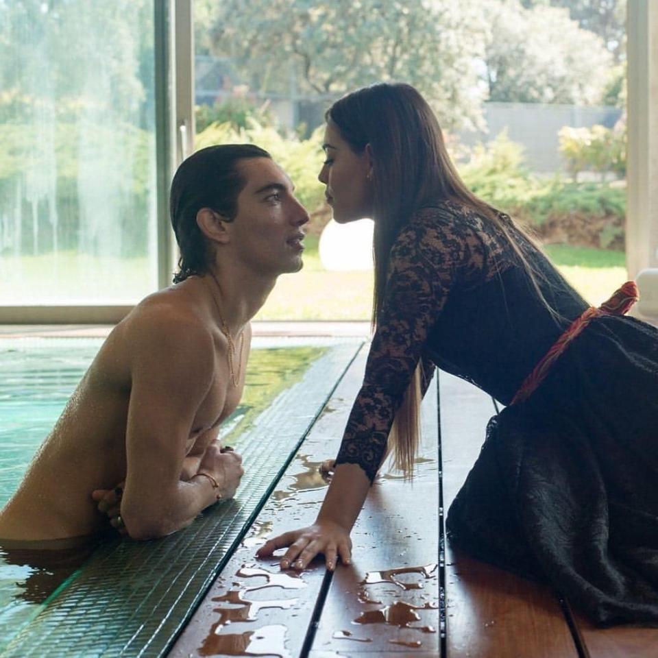 lu and valerio near kissing by the pool