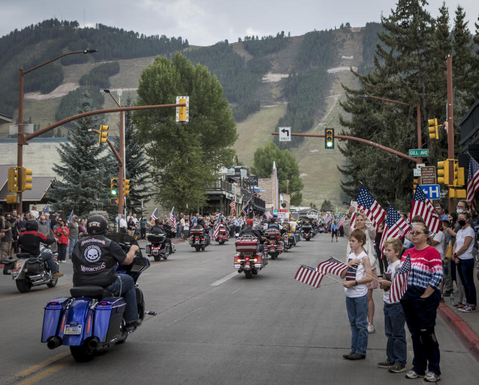 Community members honor Marine Lance Cpl. Rylee McCollum during a procession in Jackson, Wyo., Friday, Sept. 10, 2021. McCollum was one of the service members killed in Afghanistan after a suicide bomber attacked Hamid Karzai International Airport on Aug. 26. (AP Photo/Amber Baesler)