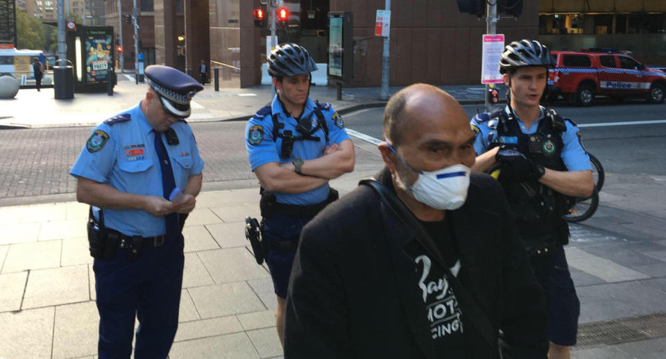 Lance Priestley of Sydney 24/7 Street Kitchen and Safe Space Community being moved on by police in Sydney's Martin Place on Friday.